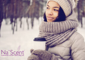 Dreamful young woman standing in winter forest